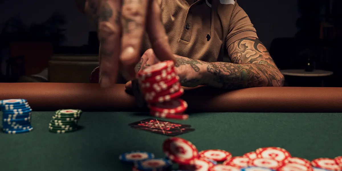 Player betting chips at a poker table in Pot Limit Omaha.