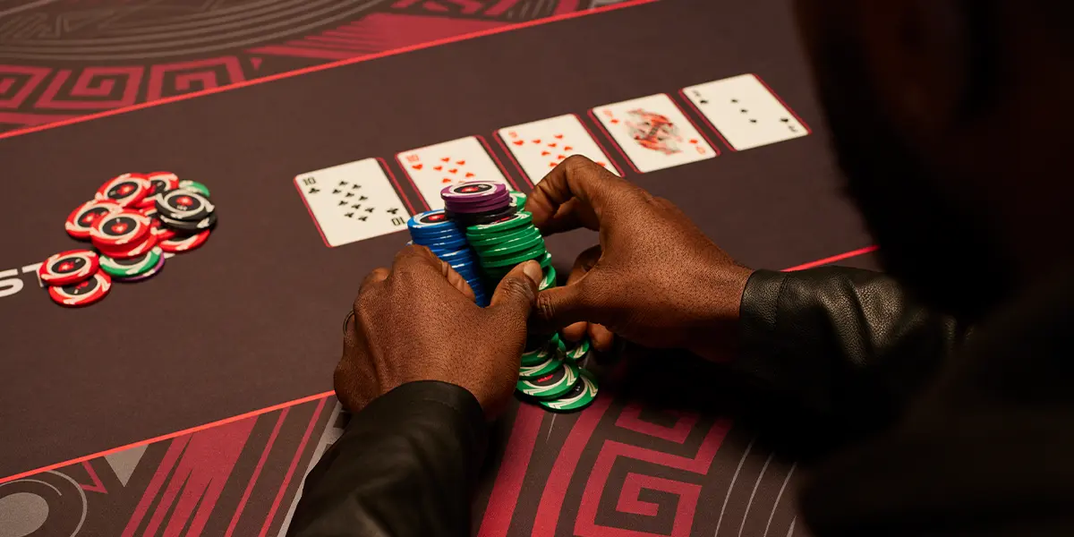 Detailed view of poker chips being pushed into the pot, representing the risks of over-playing mediocre hands on the turn.