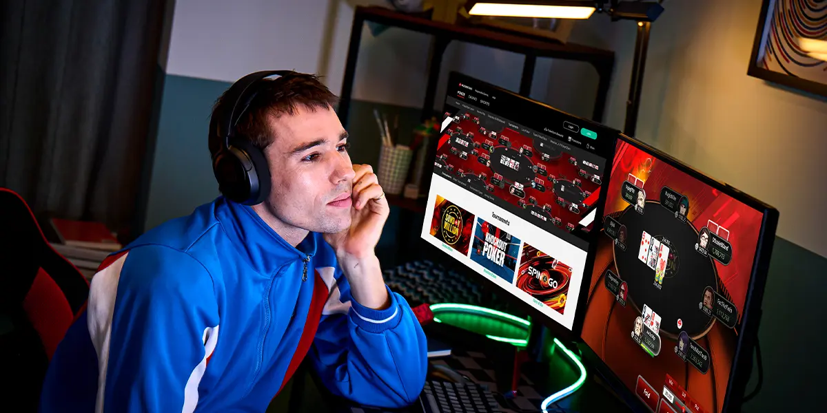 A poker player playing an online game on PokerStars using a computer.