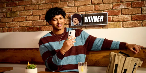 A poker player smiling after winning an online poker tournament at PokerStars on their smartphone.
