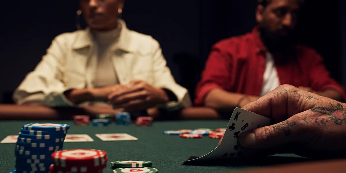 Player looks down at king-eight suited before making a hero call.