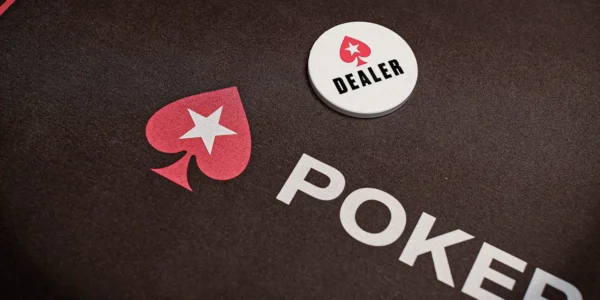 A white poker dealer button on a poker table felt.